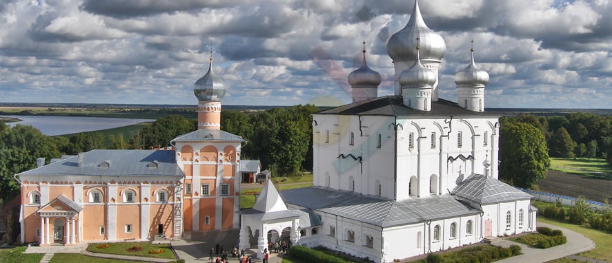 A white building with silver domes Description automatically generated